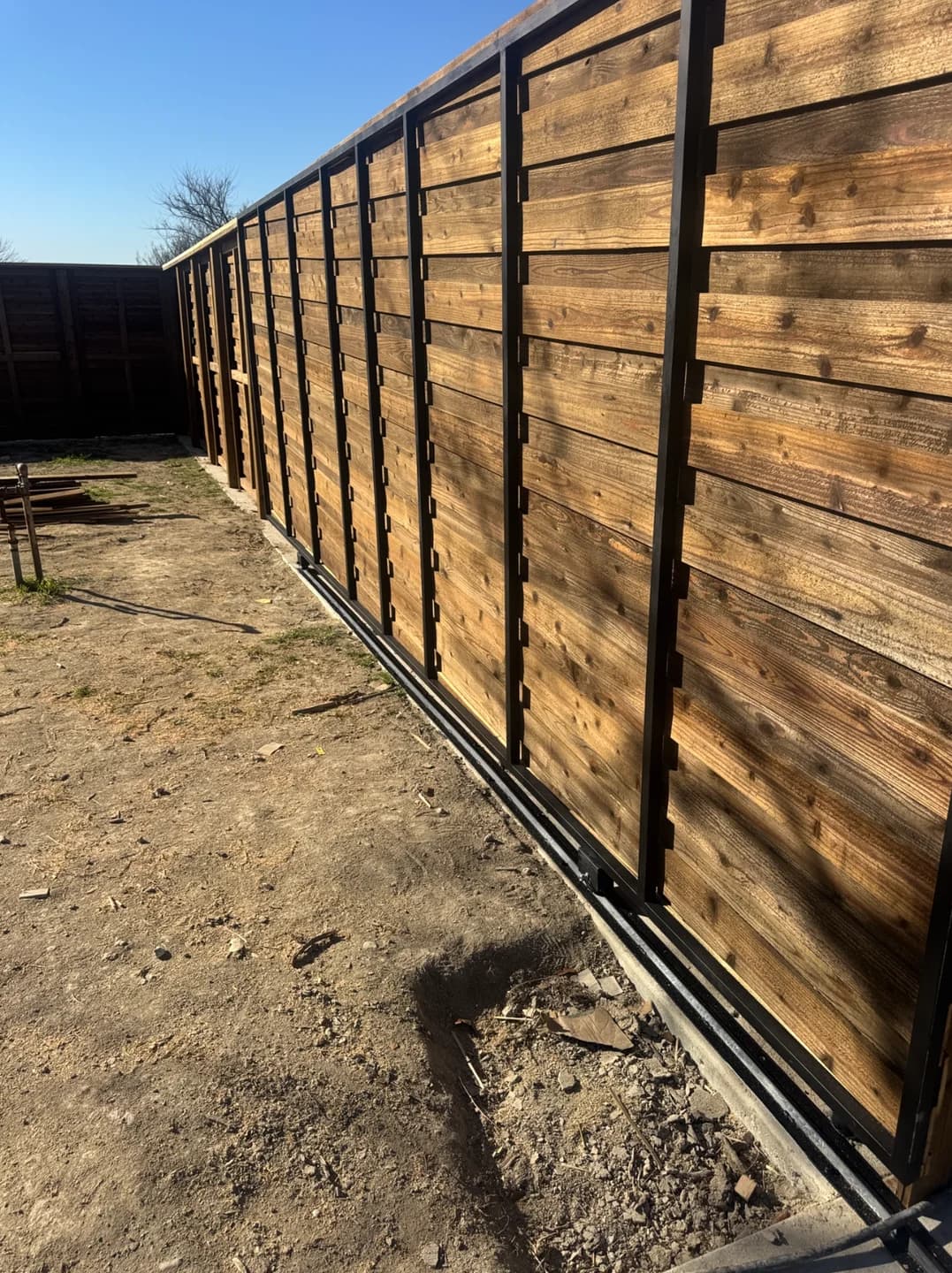 Completed horizontal cedar privacy fence on steel posts in Heath.