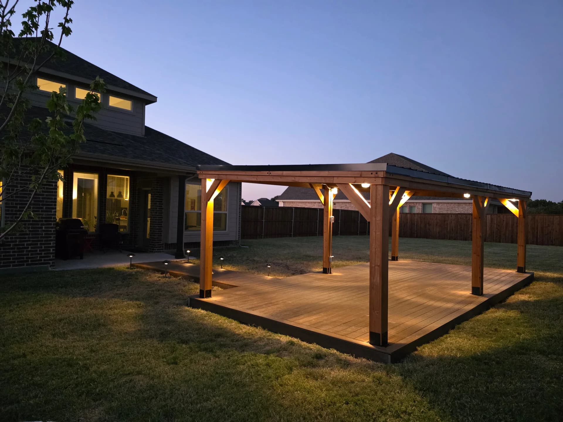 Custom cedar pergola with integrated post lighting built by i30 Builders - DFW East Texas